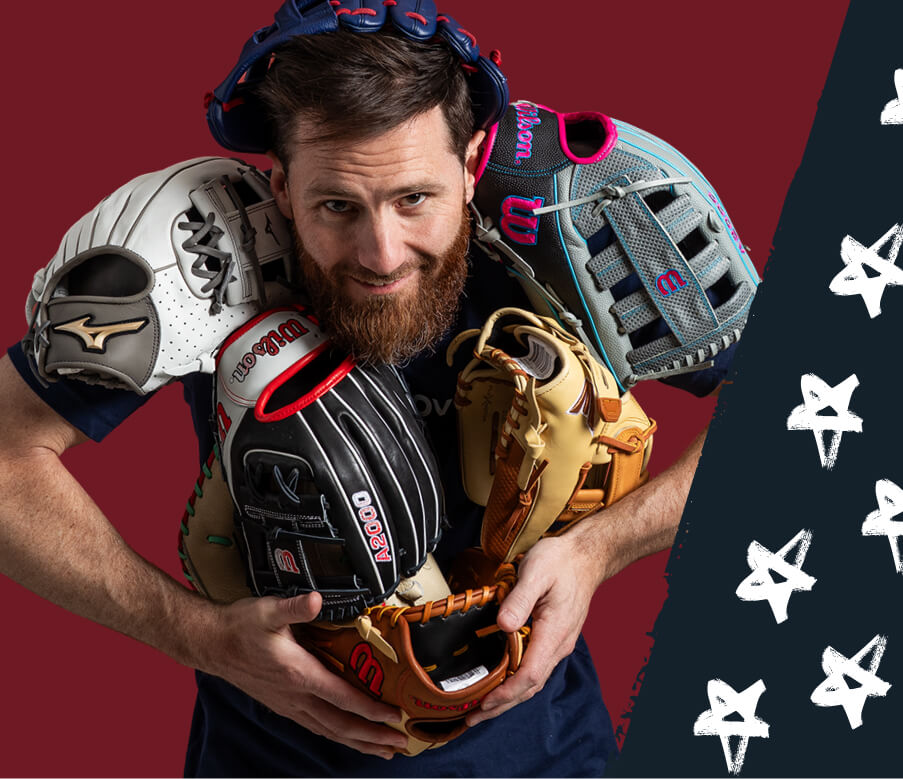 A man with a beard holds multiple baseball gloves, including Wilson and Mizuno brands. The gloves are in various colors and styles.