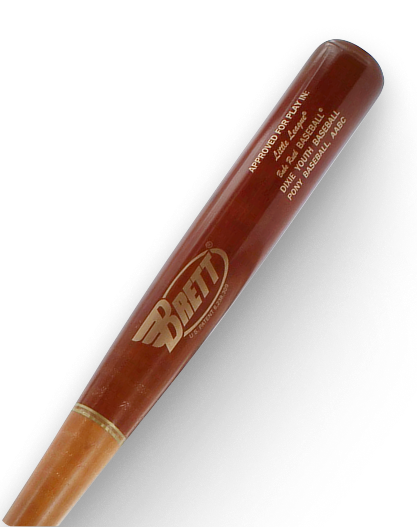 A wooden baseball bat with "BRETT" logo. Text reads: "APPROVED FOR PLAY IN: Little League, Babe Ruth Baseball, DIXIE YOUTH BASEBALL, PONY BASEBALL AABC".