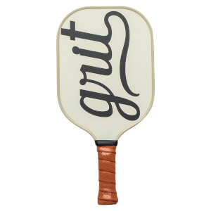 Front view of a cream pickleball paddle with black grit text and a brown grip.