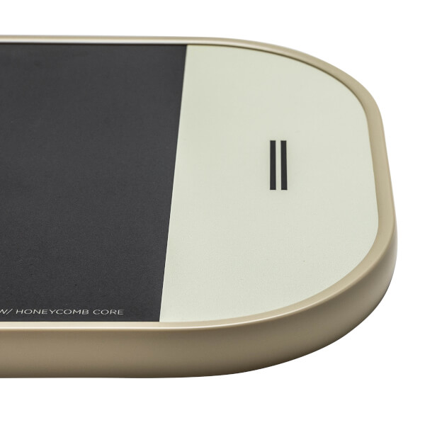 Corner view of a beige pickleball paddle with black and cream panels and a double vertical line logo.