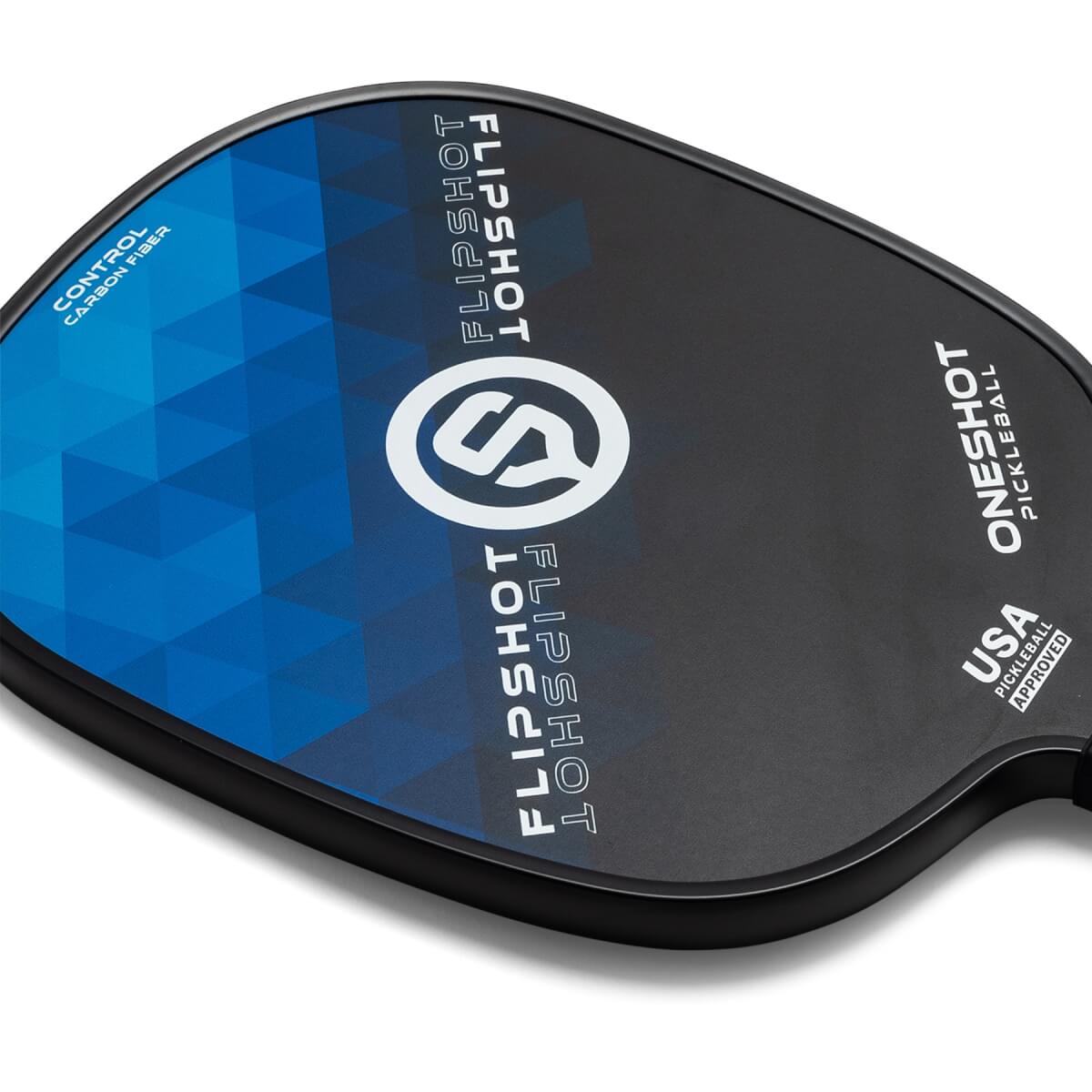 Top-down view of a black pickleball paddle with blue geometric design, FLIPSHOT text, and USA PICKLEBALL APPROVED stamp.