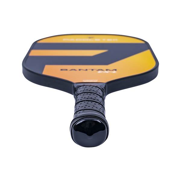 Top-down view of a black and orange pickleball paddle with BANTAM EX-L text and a perforated grip.