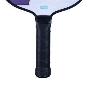 Close-up of a black pickleball paddle grip with USAPA APPROVED text on the paddle head.