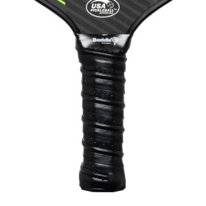 Close-up of a black pickleball paddle grip with Baddle branding and USA Pickleball Approved logo.