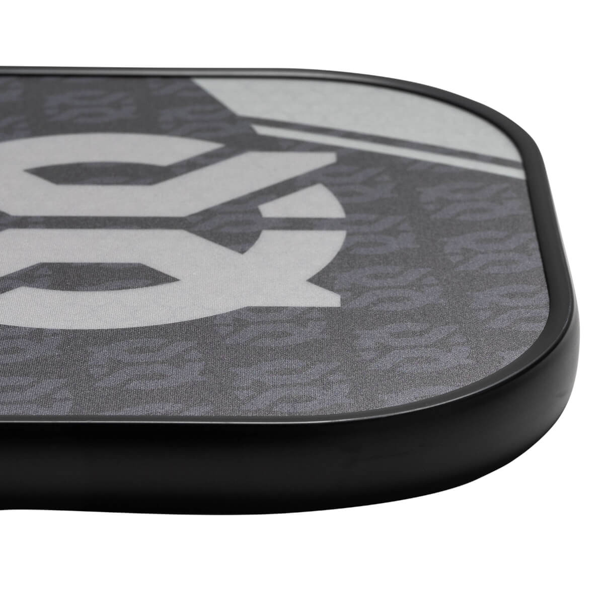 Corner view of a gray pickleball paddle with a large white graphic and black edge.
