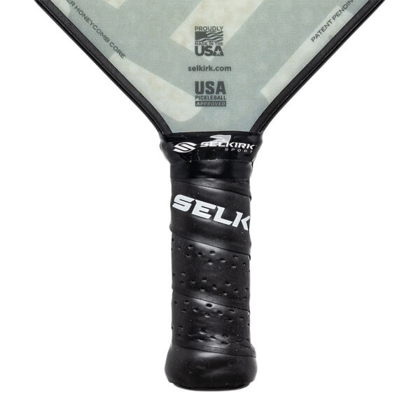 Close-up of a black pickleball paddle grip with SELKIRK SPORT and SELK branding, and USA PICKLEBALL APPROVED text.