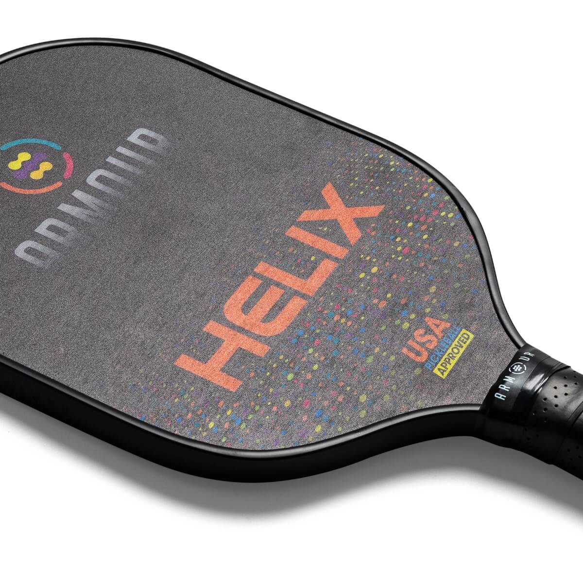 Top-down view of a black pickleball paddle with orange HELIX text, colorful speckles, and USA Pickleball Approved logo.