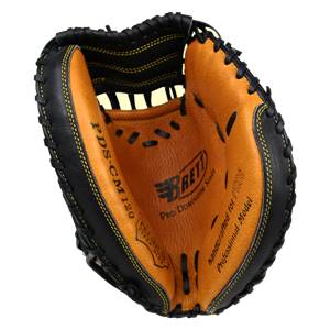 Top-down view of a black and tan catchers mitt with PDS-CM120 and Brett Pro Dominator Series text.