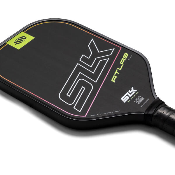Top-down view of a black pickleball paddle with white SK logo, yellow ATLAS XL text, and a gradient edge.