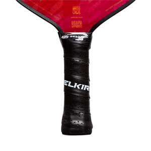 Close-up of a black pickleball paddle grip with ELKIR branding and perforated texture.