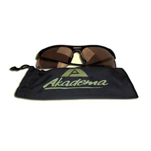 Front view of black sunglasses with brown lenses and a black pouch with the Akadema logo.