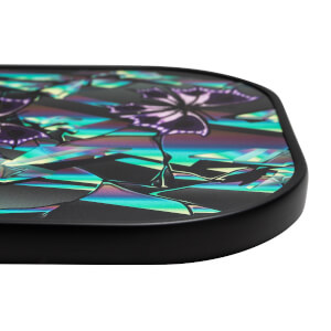 Corner view of a black pickleball paddle with iridescent butterfly graphics and a geometric pattern.