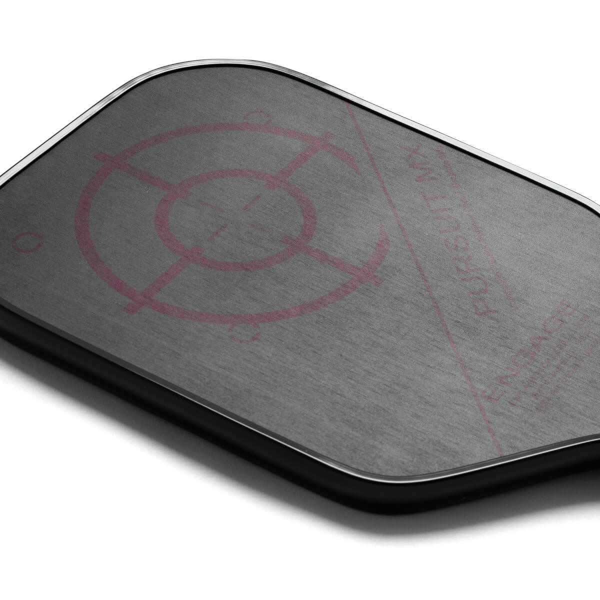 Top-down view of a gray pickleball paddle with a pink target design and visible text.