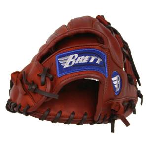 Top-down view of a brown baseball glove with a blue Brett patch and a white wing logo.