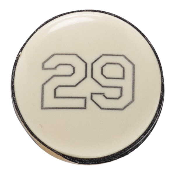 Close-up of a cream baseball bat end cap with a glossy finish and the number 29 outlined in black.