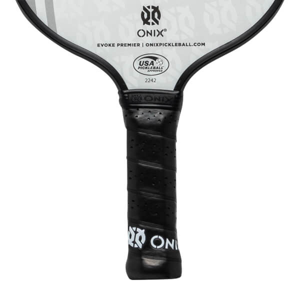 Close-up of a black pickleball paddle grip with perforated texture and ONIX branding.
