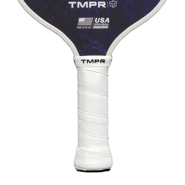 Close-up of a white grip on a pickleball paddle with TMPR branding and USA Pickleball Approved logo.