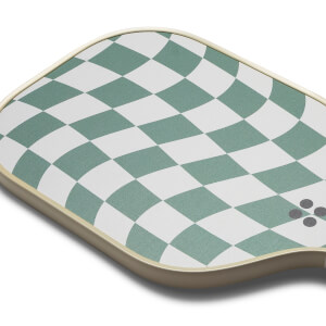 Top-down view of a green and white pickleball paddle with a checkered pattern and four grey dots.