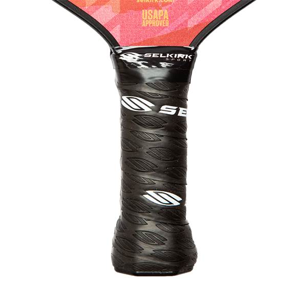 Close-up of a black pickleball paddle grip with leaf pattern and white SE logo.