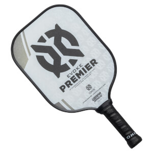 Top-down view of a white pickleball paddle with black branding, EVOKE PREMIER text, and a textured grip.