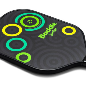 Corner view of a black pickleball paddle with green and yellow circles and Baddle junior text.