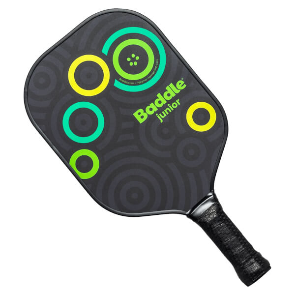 Front view of a black Baddle Junior pickleball paddle with green and yellow circles and concentric ring pattern.
