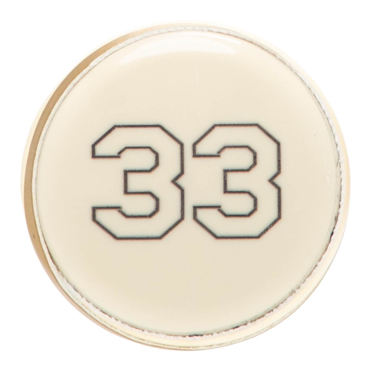 Close-up of a cream circular softball bat end cap with a thin gold rim and the number 33 in black outline.