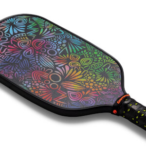 Corner view of a black pickleball paddle with a rainbow-colored abstract pattern and GAMMA branding.