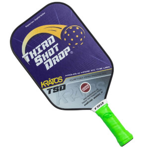 Corner view of a purple pickleball paddle with Third Shot Drop logo and green grip.