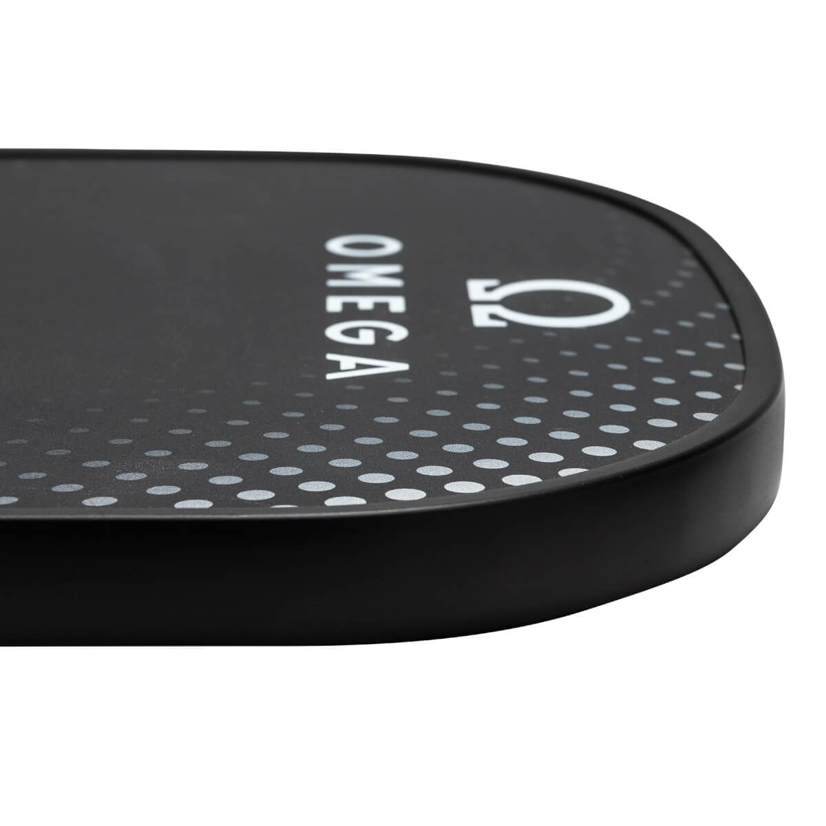Corner view of a black pickleball paddle with white OMEGA text and a dotted pattern.