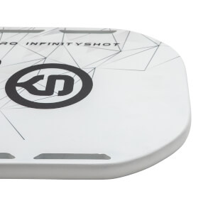 Corner view of a white pickleball paddle with black INFINITYSHOT text and a black logo.