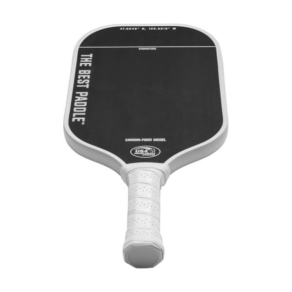 Top-down view of a white and black pickleball paddle with THE BEST PADDLE text and USA Pickleball logo.