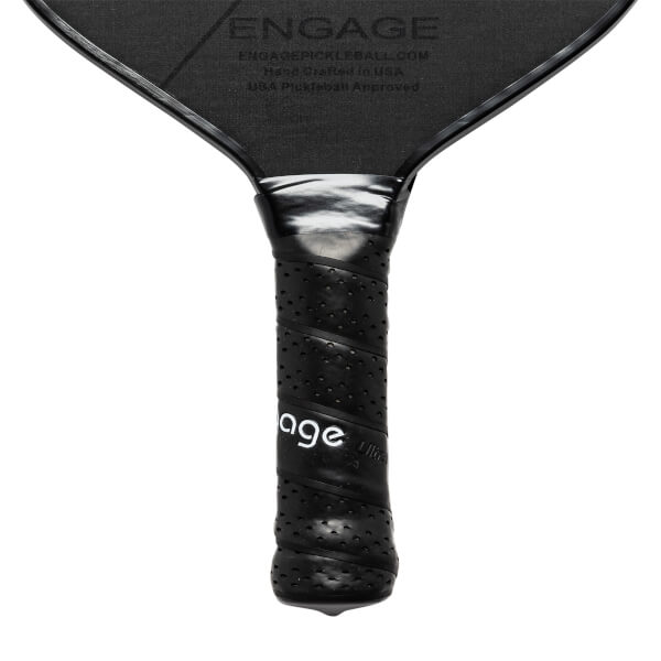 Close-up of a black pickleball paddle grip with perforated texture and Engage branding.