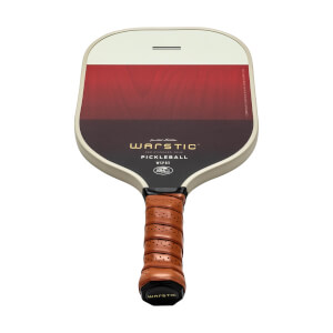 Front view of a cream and red pickleball paddle with Warstic branding and a brown grip.