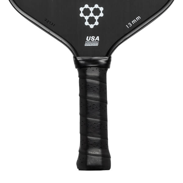 Top-down view of a black pickleball paddle with a white honeycomb logo, USA PICKLEBALL APPROVED text, and 13 mm marking.