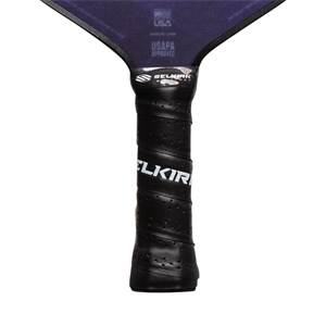 Close-up of a black pickleball paddle grip with white SELKIRK text and USAPA approved logo.