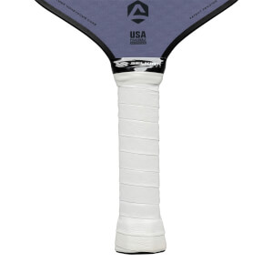Close-up of a white grip on a purple pickleball paddle with USA Pickleball Approved and Selkirk logos.