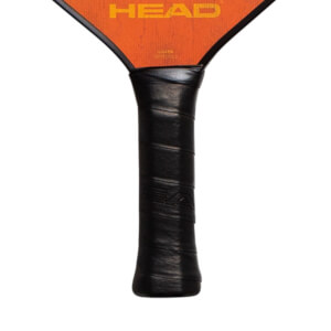 Close-up of a black pickleball paddle grip with orange HEAD branding on the paddle face.
