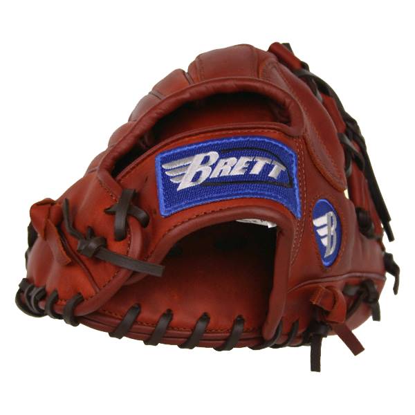 Top-down view of a brown baseball glove with a blue Brett patch and a white wing logo.