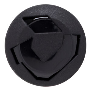 Top-down view of a circular black cap featuring a matte textured outer rim and a stylized geometric shield logo in the center against a glossy background.