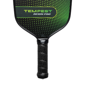 Top-down view of a black pickleball paddle with green TEMPEST REIGN PRO text and a textured grip.