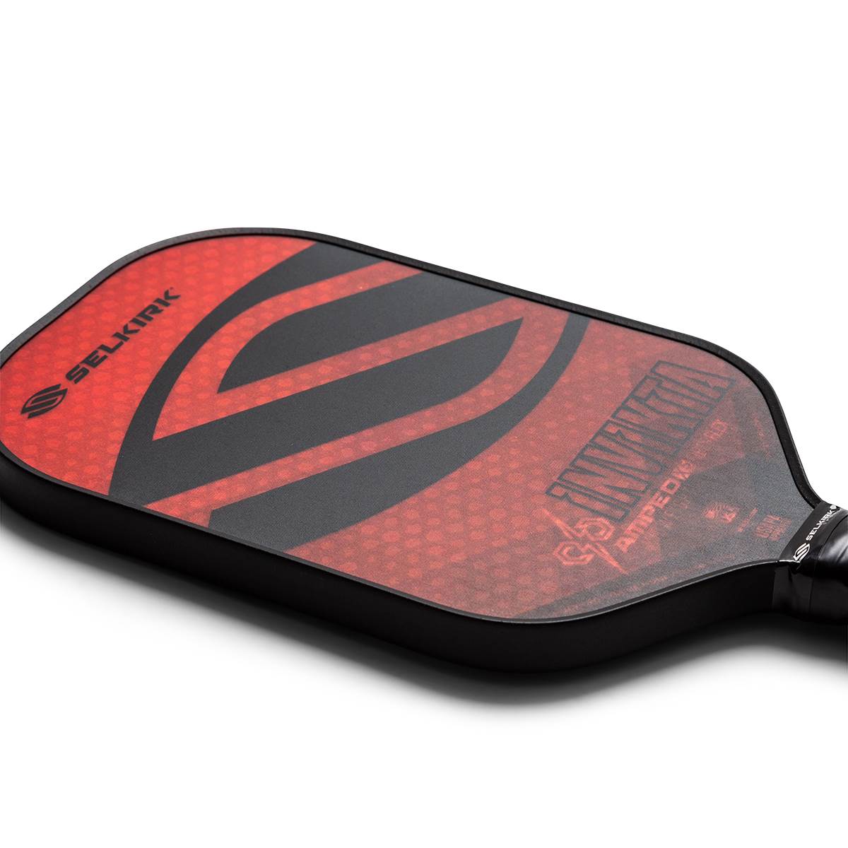 Corner view of a red and black pickleball paddle with Selkirk branding and Invikta text.