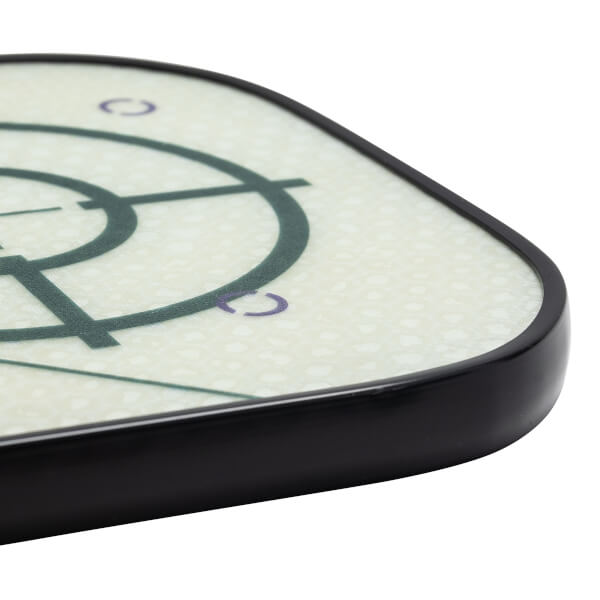 Corner view of a white pickleball paddle with a dark green target design and purple accents.