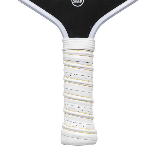 Close-up of a white pickleball paddle grip with yellow trim and black perforations.