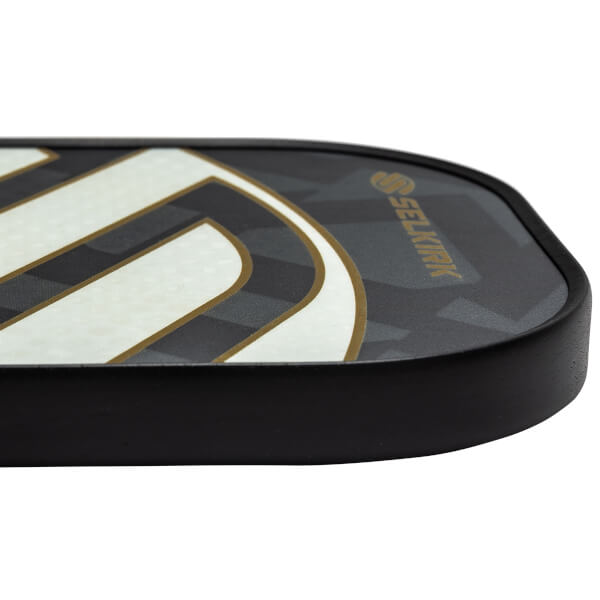 Side view of a black pickleball paddle with white and gold curved lines and Selkirk branding.