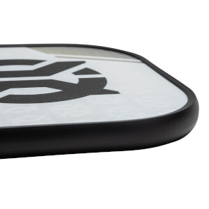 Corner view of a white pickleball paddle with a black border and a large black graphic.