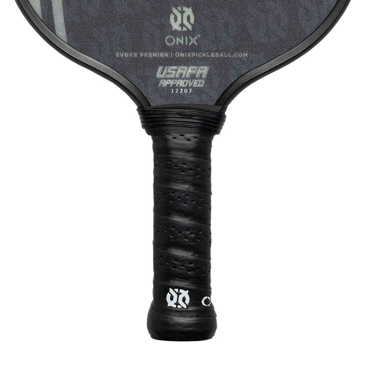 Close-up of a black pickleball paddle grip with perforated texture and USAPA approved stamp.