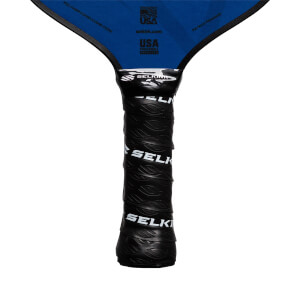 Close-up of a black pickleball paddle grip with repeating SELKIRK text and leaf-like texture.