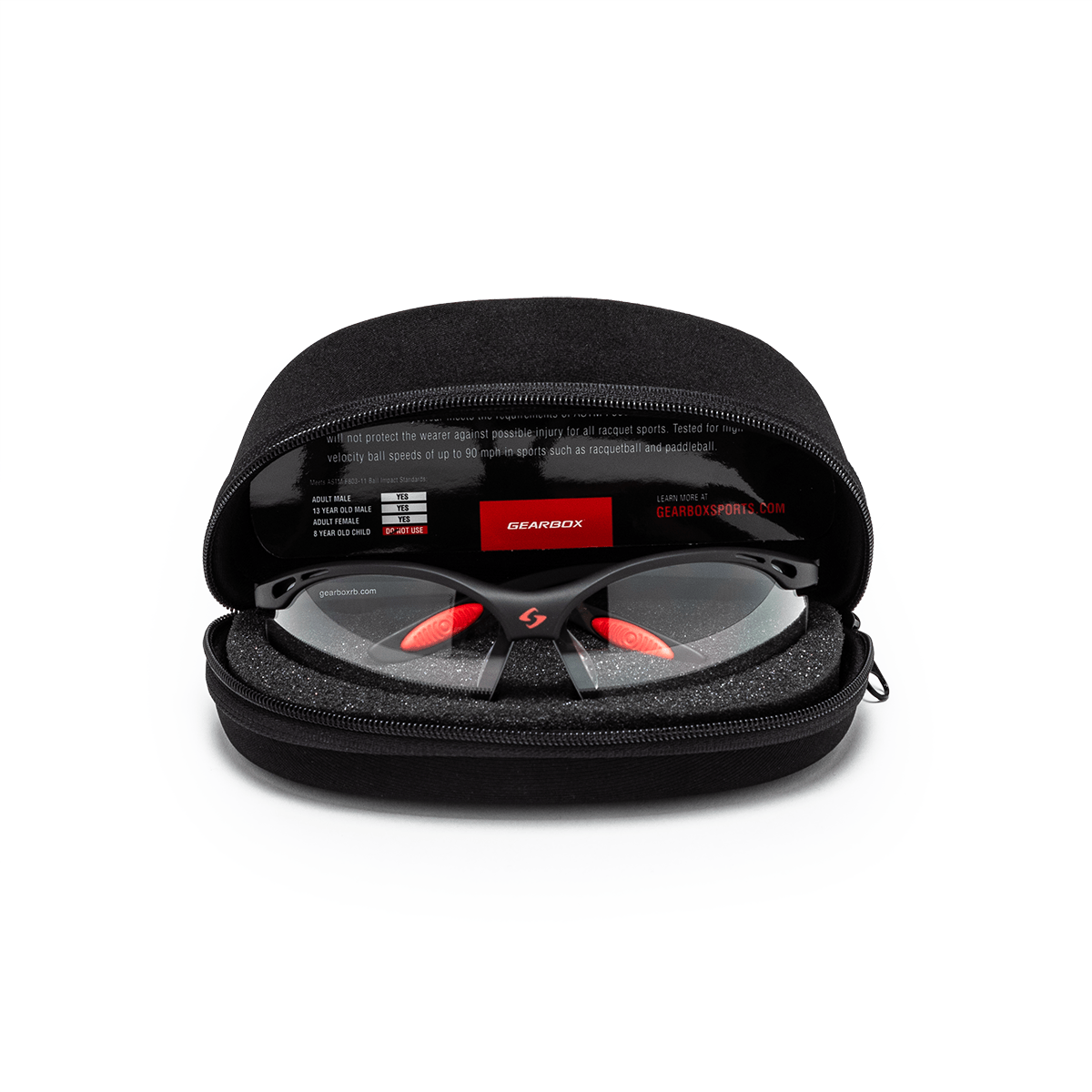 Front view of black sports glasses with red nose pads and orange accents inside a black protective case, showing the "GEARBOX" logo.