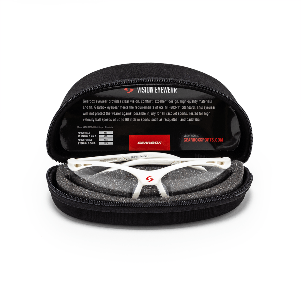Front view of white safety glasses with a red Gearbox logo, resting in a black case.